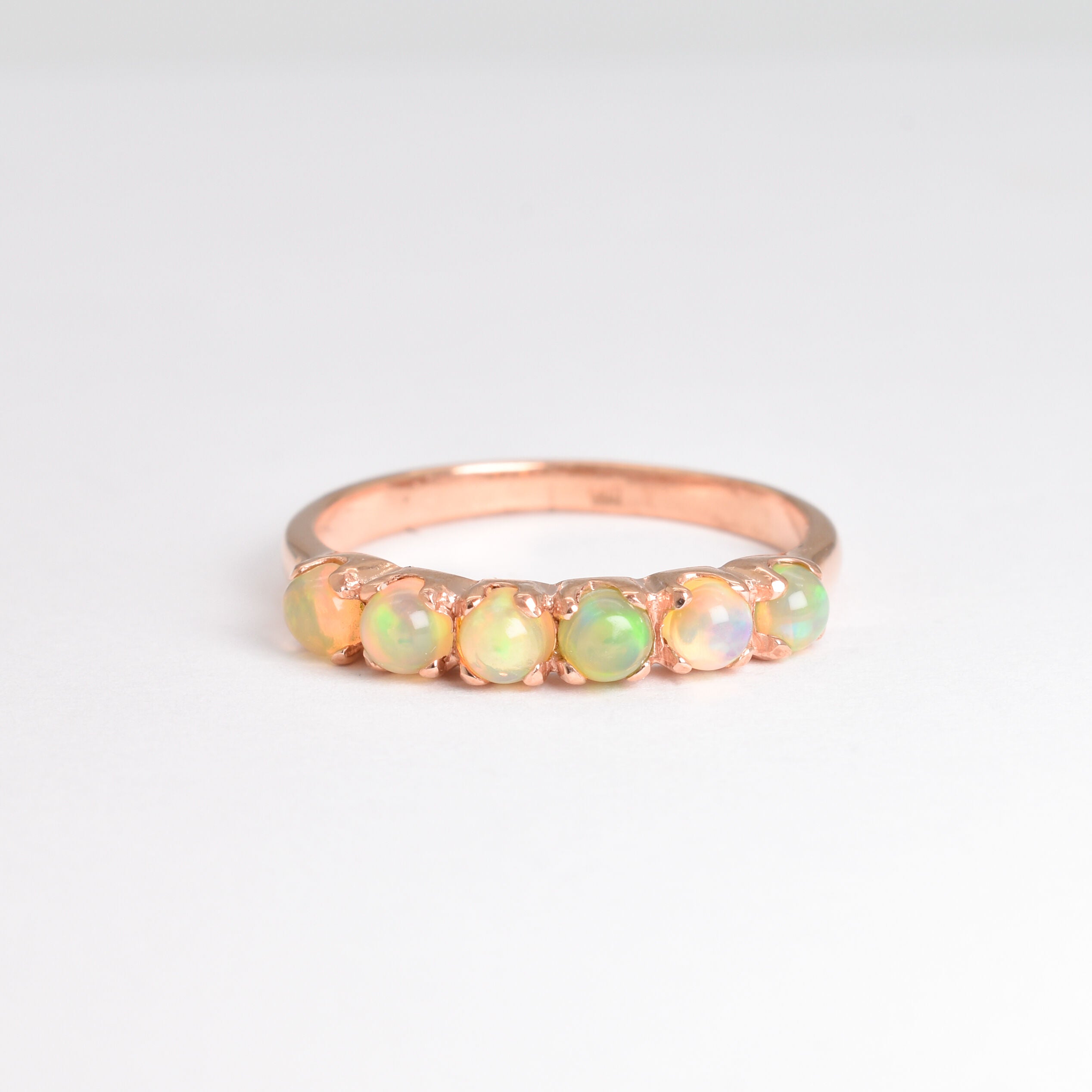 Ethiopian Opal eternity ring in rose gold with round cabochon gemstones, ideal for stacking or wearing solo, symbolizing everlasting love and inspiration, a meaningful October birthstone gift for weddings, anniversaries, and romantic milestones.