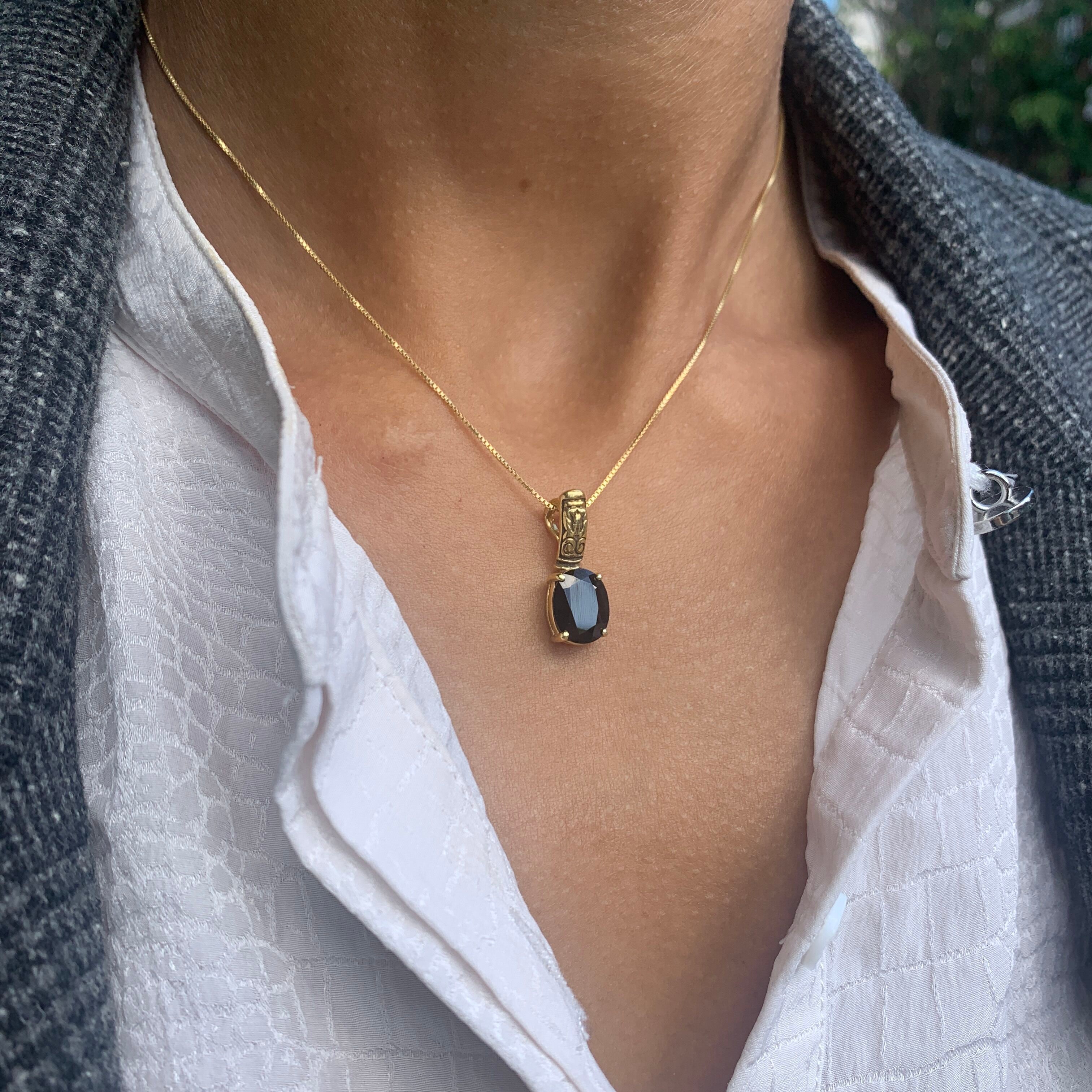 Onyx pendant known for grounding benefits and promoting inner strength.