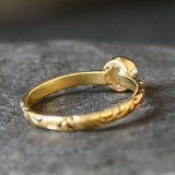 Bezel Opal ring with engraved gold band in a tribal boho style. The opal displays fire colors and flashing rainbow tones, symbolizing hope, creativity and emotional balance. A unique October birthstone gift perfect for anniversaries, festivals, weddings and special celebrations.