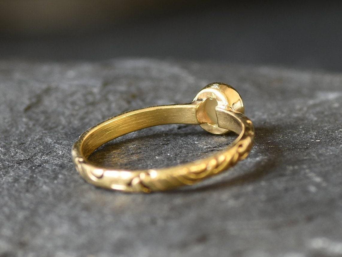 Bezel Opal ring with engraved gold band in a tribal boho style. The opal displays fire colors and flashing rainbow tones, symbolizing hope, creativity and emotional balance. A unique October birthstone gift perfect for anniversaries, festivals, weddings and special celebrations.