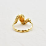 Vintage Opal Ring in a bezel set gold wave design with flashes of rainbow and fire colors, accented by sparkling CZ Diamonds on each curve. Opal is believed to inspire creativity, hope and emotional balance, making it a meaningful October birthstone gift for anniversaries, engagements, weddings and special celebrations.