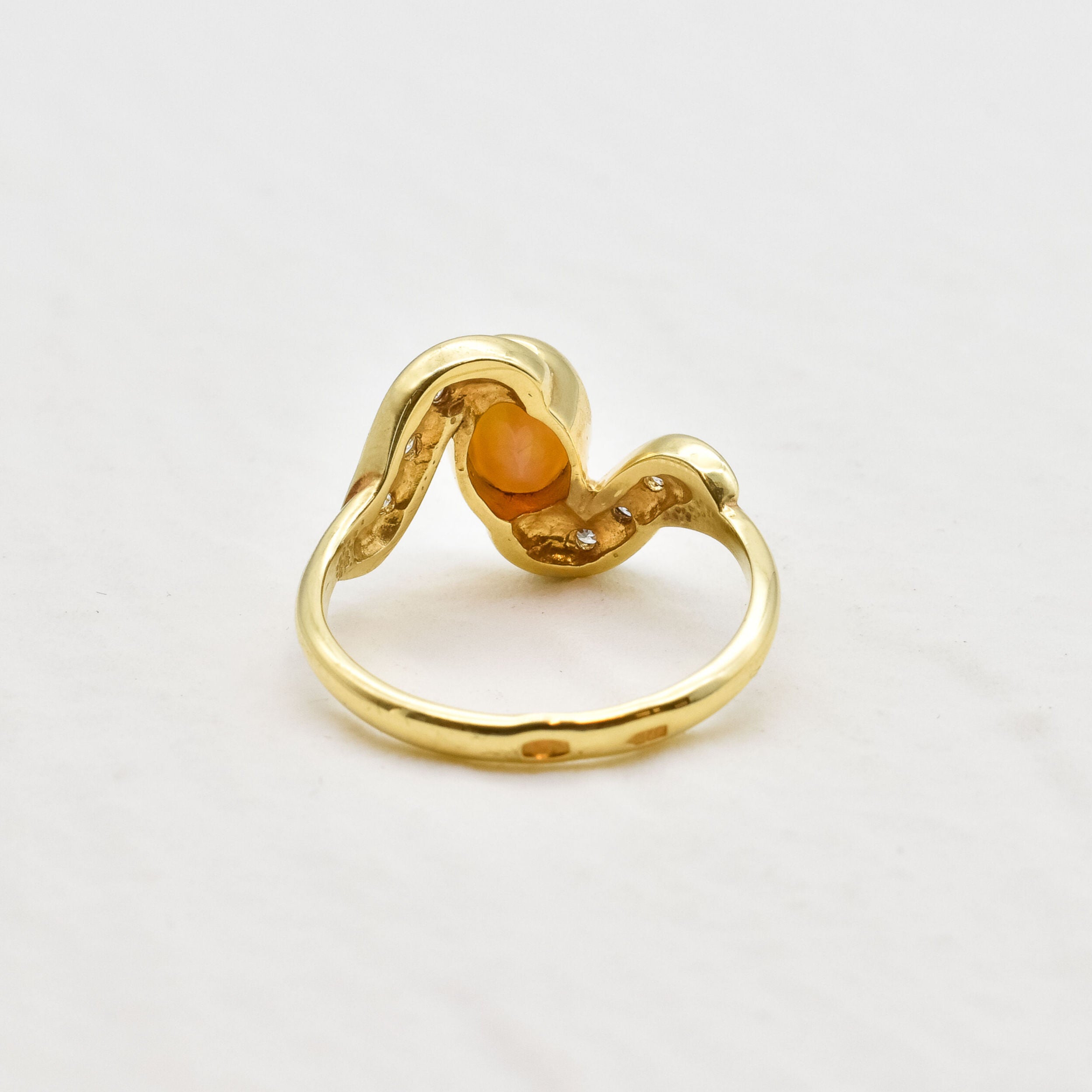 Vintage Opal Ring in a bezel set gold wave design with flashes of rainbow and fire colors, accented by sparkling CZ Diamonds on each curve. Opal is believed to inspire creativity, hope and emotional balance, making it a meaningful October birthstone gift for anniversaries, engagements, weddings and special celebrations.