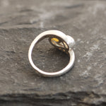 Two-Stone Opal Bypass Wave Ring in sterling silver showcasing cabochon-cut opals with flashes of fire colors and CZ pave accents for an elegant jewelry style. Known for enhancing emotional clarity and balance, this October birthstone ring makes a thoughtful and meaningful gift idea. Perfect for anniversaries, weddings, cocktail events, and celebratory occasions where sophistication shines.