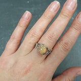 Flower Opal Ring worn on middle finger with bare natural nails, showcasing a leafy vine cabochon setting, perfect for connecting with nature and creativity, a thoughtful October birthstone gift, suitable for garden parties and evening gatherings.