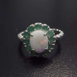Opal halo floral ring with Genuine Emeralds in a vintage victorian flower halo, White cabochon center, and beaded Bubble Band for a bold statement cocktail look showing flashes of fire colors. Benefits include creativity, harmony, and calm. Ideal October birthstone gift with meaningful May emerald accents.
Worn for weddings, cocktail parties, anniversaries, graduations, garden events, and holiday gatherings.