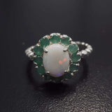 Opal halo floral ring with Genuine Emeralds in a vintage victorian flower halo, White cabochon center, and beaded Bubble Band for a bold statement cocktail look showing flashes of fire colors. Benefits include creativity, harmony, and calm. Ideal October birthstone gift with meaningful May emerald accents.
Worn for weddings, cocktail parties, anniversaries, graduations, garden events, and holiday gatherings.