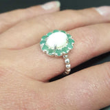 Opal halo floral ring with Genuine Emeralds in a vintage victorian flower halo, White cabochon center, and beaded Bubble Band for a bold statement cocktail look showing flashes of fire colors. Benefits include creativity, harmony, and calm. Ideal October birthstone gift with meaningful May emerald accents.
Worn for weddings, cocktail parties, anniversaries, graduations, garden events, and holiday gatherings.