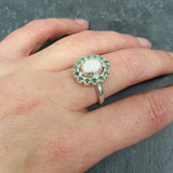 Australian Opal Emerald Halo Ring worn on middle finger with natural nails, perfect for inspiring emotional balance and prosperity, ideal for anniversaries and romantic dinners