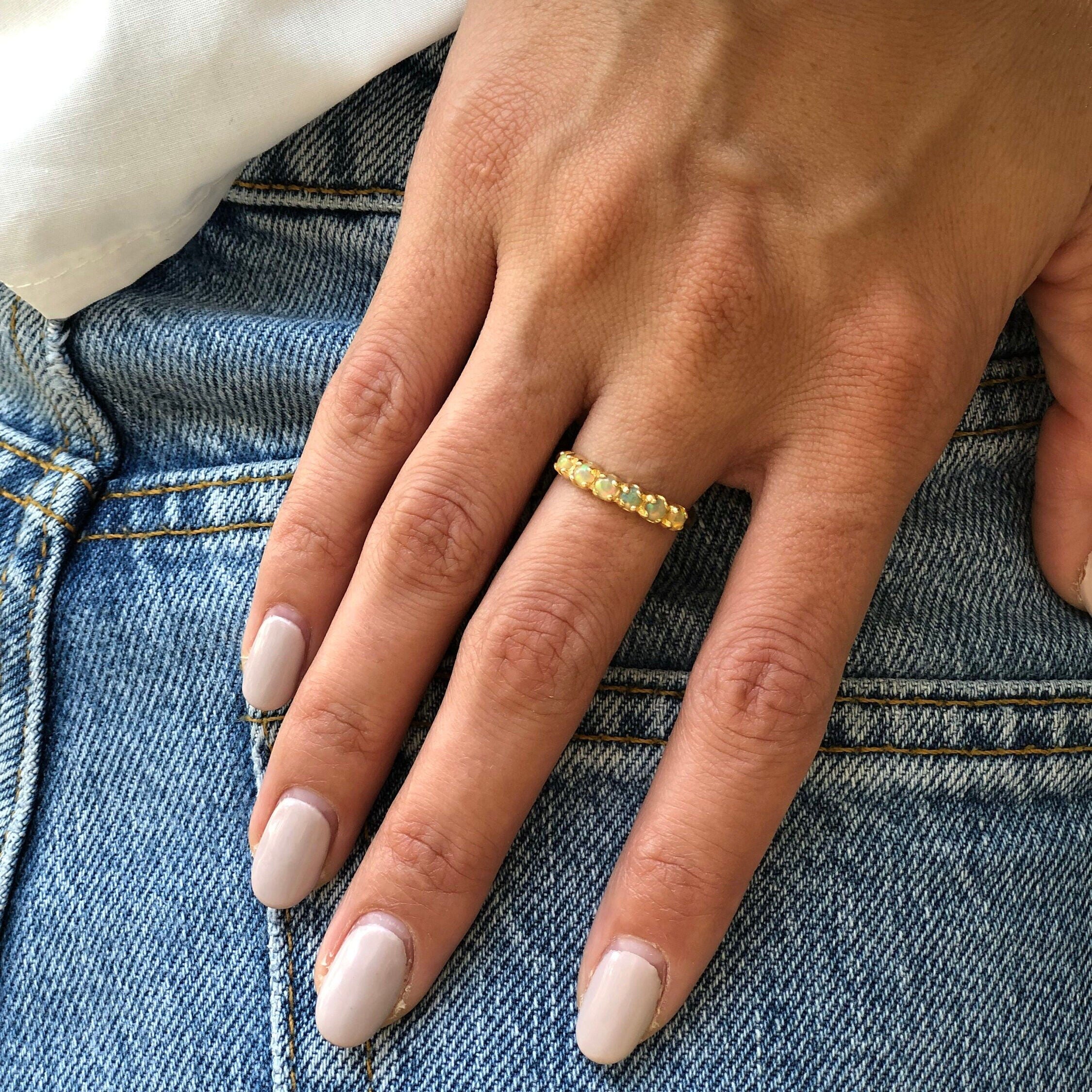 Ethiopian Opal Eternity Band stacked with colorful gemstone rings, worn with nude manicure and denim outfit, perfect for adding sparkle to everyday style and believed to boost inspiration, great for casual meetups and creative workdays.