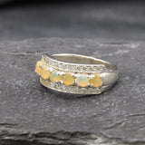 Opal Row Half Eternity Wide Ring in sterling silver featuring natural fire opals with flashes of fire colors, accented by CZ pave for a bold jewelry style. A meaningful October birthstone piece symbolizing balance and inspiration, making it a treasured gift idea. Perfect for weddings, anniversaries, cocktail events, and elegant evening occasions.