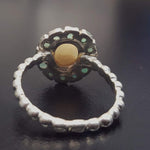 Opal halo floral ring with Genuine Emeralds in a vintage victorian flower halo, White cabochon center, and beaded Bubble Band for a bold statement cocktail look showing flashes of fire colors. Benefits include creativity, harmony, and calm. Ideal October birthstone gift with meaningful May emerald accents.
Worn for weddings, cocktail parties, anniversaries, graduations, garden events, and holiday gatherings.