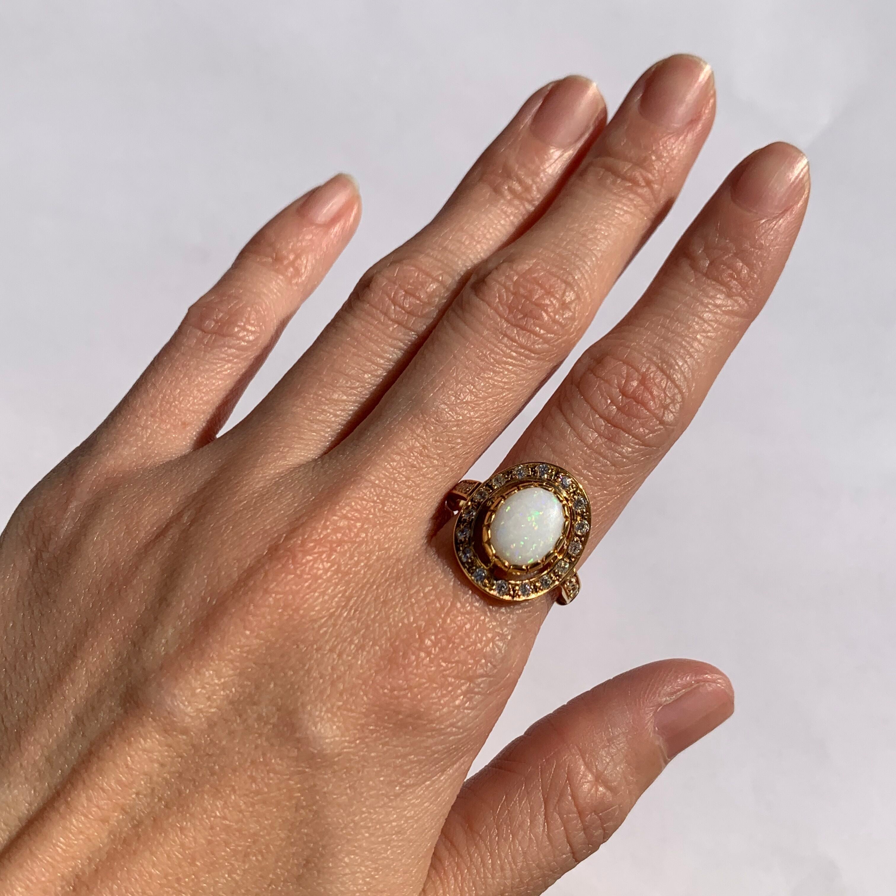 Australian Opal and CZ Diamond Halo Ring in gold worn with natural manicure, perfect for making a statement while inspiring creativity and charm, ideal for weddings, galas, and special celebrations.