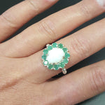Opal Emerald Halo Ring, October Birthstone worn on the middle finger with bare nails, the floral halo and beaded Bubble Band catching flashes of fire colors, perfect for boosting creativity and calm during brunch dates and daytime outings. Worn for weddings, cocktail parties, anniversaries, graduations, garden events, and holiday gatherings.