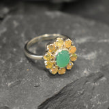 Chrysoprase and Opal Flower Ring in sterling silver featuring a green cabochon chrysoprase center framed with diamond cut opal petals, a statement jewelry style that enhances confidence and creativity while offering flashes of fire colors, making it a meaningful October birthstone gift idea. Perfect for weddings, formal dinners, and festive occasions to showcase elegance and charm.