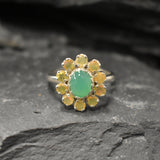 Chrysoprase and Opal Flower Ring in sterling silver featuring a green cabochon chrysoprase center framed with diamond cut opal petals, a statement jewelry style that enhances confidence and creativity while offering flashes of fire colors, making it a meaningful October birthstone gift idea. Perfect for weddings, formal dinners, and festive occasions to showcase elegance and charm.