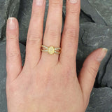 Opal Ring styled on a bare hand with minimal accessories, featuring a split shank band and CZ pave sparkle. Enhances positivity and inspiration, making it an ideal October birthstone present. Suitable for work meetings, cocktail parties, and weekend gatherings.