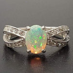 Opal Ring with split shank band and CZ pave setting showing flashes of fire colors, designed as elegant fine jewelry. Known for its emotional healing and creativity benefits, Opal is also the October birthstone and a thoughtful gift for birthdays or anniversaries. Perfect to wear at weddings, romantic dinners, and special evening celebrations.