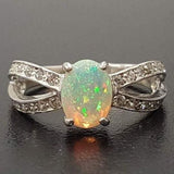 Opal Ring with split shank band and CZ pave setting showing flashes of fire colors, designed as elegant fine jewelry. Known for its emotional healing and creativity benefits, Opal is also the October birthstone and a thoughtful gift for birthdays or anniversaries. Perfect to wear at weddings, romantic dinners, and special evening celebrations.
