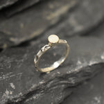 Opal Ring in sterling silver with a hammered textured band and bezel set white opal that shows flashes of fire colors. Opal is linked to creativity, inspiration and emotional balance, making it a meaningful October birthstone gift. A perfect present for birthdays, anniversaries or promise rings. Suitable for daily wear, weddings, parties and special occasions.