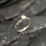 Opal Ring in sterling silver with a hammered textured band and bezel set white opal that shows flashes of fire colors. Opal is linked to creativity, inspiration and emotional balance, making it a meaningful October birthstone gift. A perfect present for birthdays, anniversaries or promise rings. Suitable for daily wear, weddings, parties and special occasions.