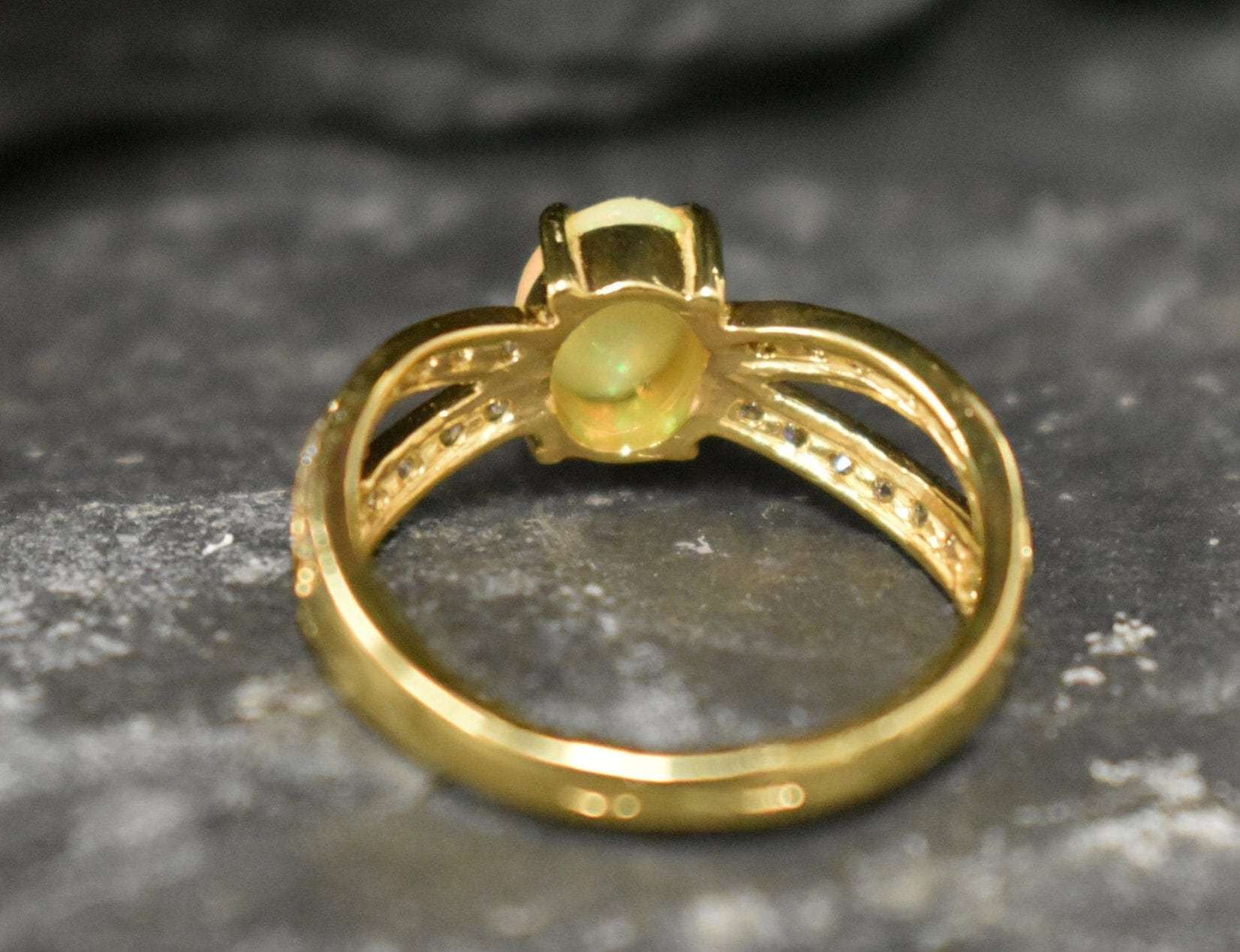 Opal Ring with split shank band and CZ pave setting showing flashes of fire colors, designed as elegant fine jewelry. Known for its emotional healing and creativity benefits, Opal is also the October birthstone and a thoughtful gift for birthdays or anniversaries. Perfect to wear at weddings, romantic dinners, and special evening celebrations.