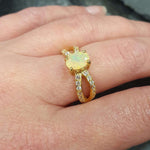 Flower Opal Ring worn on middle finger with nude nails, highlighting its split pave band and flashes of fire colors. Brings emotional balance and creativity, a meaningful October birthstone gift. Perfect for casual dinners, brunches, and daytime events.