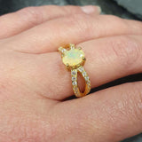 Flower Opal Ring worn on middle finger with nude nails, highlighting its split pave band and flashes of fire colors. Brings emotional balance and creativity, a meaningful October birthstone gift. Perfect for casual dinners, brunches, and daytime events.