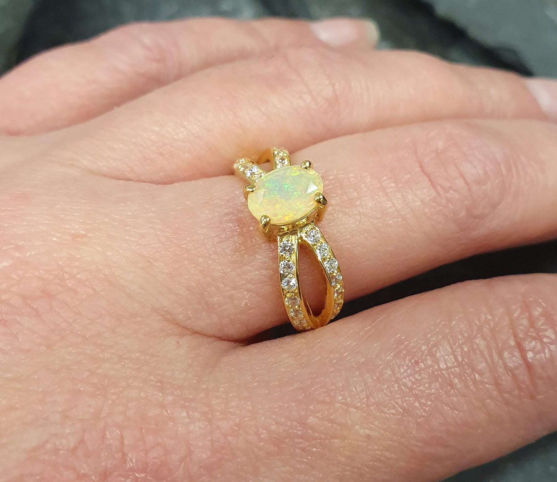 Flower Opal Ring worn on middle finger with nude nails, highlighting its split pave band and flashes of fire colors. Brings emotional balance and creativity, a meaningful October birthstone gift. Perfect for casual dinners, brunches, and daytime events.