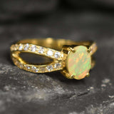 Opal Ring with split shank band and CZ pave setting showing flashes of fire colors, designed as elegant fine jewelry. Known for its emotional healing and creativity benefits, Opal is also the October birthstone and a thoughtful gift for birthdays or anniversaries. Perfect to wear at weddings, romantic dinners, and special evening celebrations.