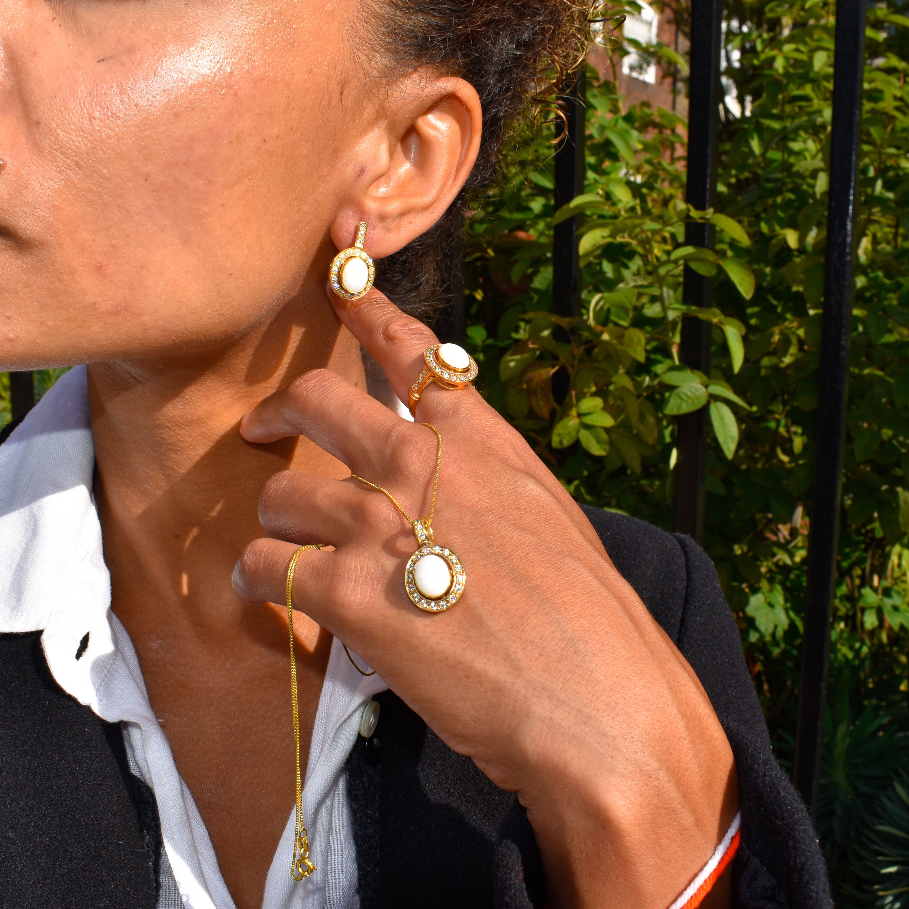 Opal ring and matching pendant set styled with a tailored black blazer and crisp white shirt, perfect for enhancing creativity and elegance, ideal for formal dinners, networking events, and milestone celebrations.
