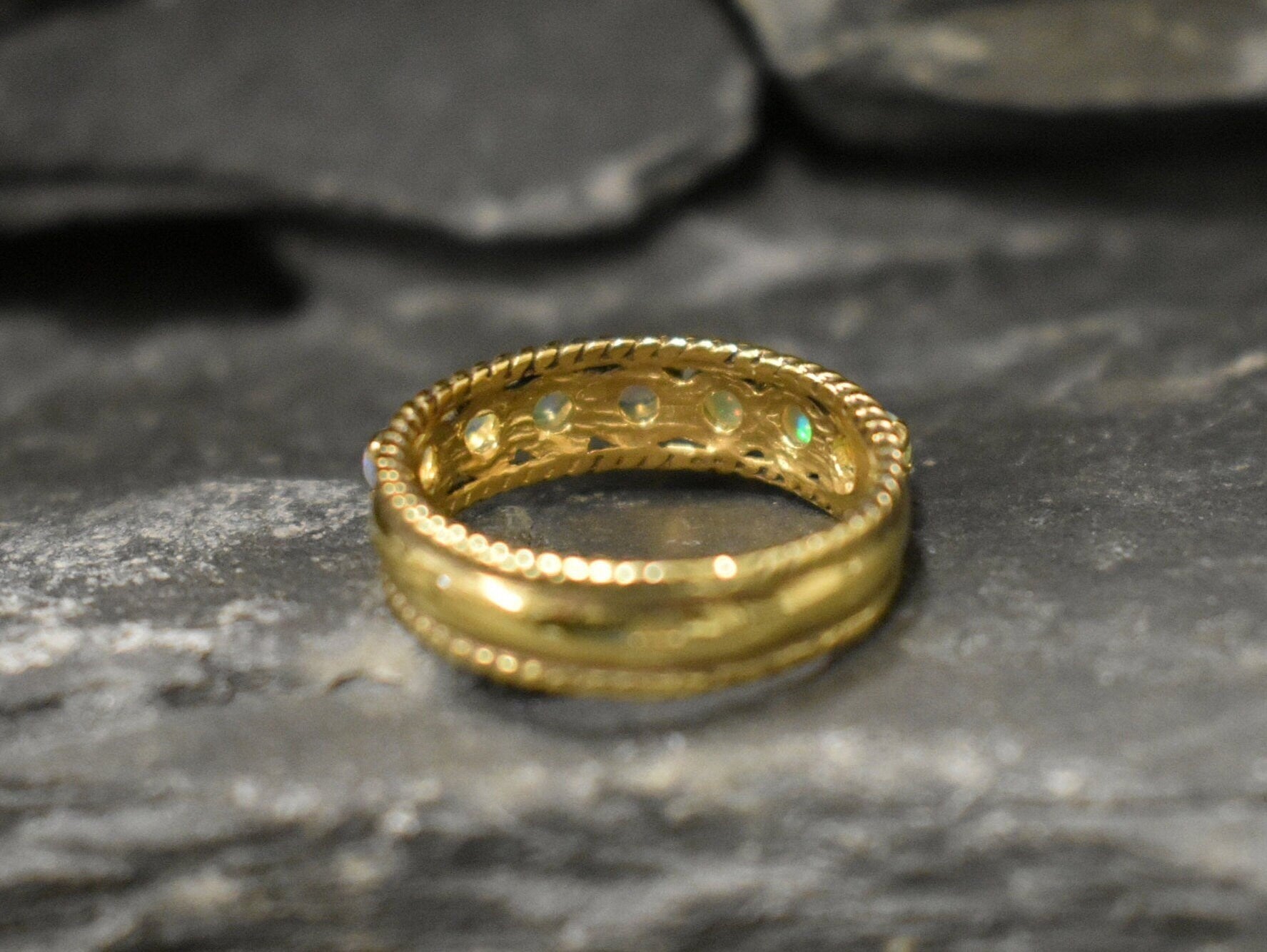 Opal Rope Row Ring featuring cabochon cut stones that highlight flashes of fire colors, offering elegance and timeless jewelry style. Known for enhancing inspiration and emotional balance, this October birthstone ring makes a meaningful gift idea. Perfect for birthdays, anniversaries, and cherished events, it can be worn to weddings, evening parties, or daily gatherings with sophistication.