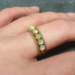 Opal Rope Row Ring worn on middle finger with nude nails, styled to highlight its cabochon opals and flashes of fire colors. A chic accessory that adds balance and clarity, ideal October birthstone jewelry gift, perfect for weddings, evening dinners, and sophisticated outings.