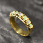 Opal Rope Row Ring featuring cabochon cut stones that highlight flashes of fire colors, offering elegance and timeless jewelry style. Known for enhancing inspiration and emotional balance, this October birthstone ring makes a meaningful gift idea. Perfect for birthdays, anniversaries, and cherished events, it can be worn to weddings, evening parties, or daily gatherings with sophistication.