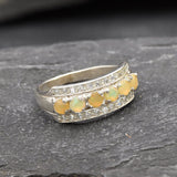 Opal Row Half Eternity Wide Ring in sterling silver featuring natural fire opals with flashes of fire colors, accented by CZ pave for a bold jewelry style. A meaningful October birthstone piece symbolizing balance and inspiration, making it a treasured gift idea. Perfect for weddings, anniversaries, cocktail events, and elegant evening occasions.