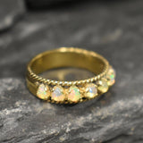 Opal Rope Row Ring featuring cabochon cut stones that highlight flashes of fire colors, offering elegance and timeless jewelry style. Known for enhancing inspiration and emotional balance, this October birthstone ring makes a meaningful gift idea. Perfect for birthdays, anniversaries, and cherished events, it can be worn to weddings, evening parties, or daily gatherings with sophistication.