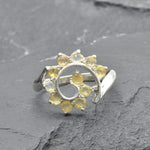 Opal Spiral Ring in sterling silver designed as a sunburst swirl statement jewelry piece offering radiant flashes of fire colors and boho charm, believed to inspire creativity and positivity, making it a thoughtful October birthstone gift idea. Perfect to wear at weddings, parties, and special occasions for a vibrant standout look.