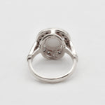 Natural Australian Opal sterling silver halo ring with an oval cabochon cut gemstone encircled by sparkling CZ Diamonds, offering a refined and timeless style. Opal, the October birthstone, is cherished for enhancing creativity and emotional balance, making it a meaningful gift for birthdays, anniversaries, engagements, weddings, and milestone celebrations.