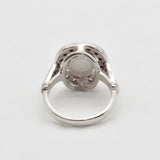 Natural Australian Opal sterling silver halo ring with an oval cabochon cut gemstone encircled by sparkling CZ Diamonds, offering a refined and timeless style. Opal, the October birthstone, is cherished for enhancing creativity and emotional balance, making it a meaningful gift for birthdays, anniversaries, engagements, weddings, and milestone celebrations.