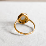 Natural Australian Opal gold ring with an oval cabochon cut gemstone framed by an intricate rope-edge design, offering a classic and elegant style. Opal, the October birthstone, is known for inspiring creativity and emotional harmony, making it an ideal gift for birthdays, anniversaries, weddings, or special celebrations.