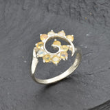 Opal Spiral Ring in sterling silver designed as a sunburst swirl statement jewelry piece offering radiant flashes of fire colors and boho charm, believed to inspire creativity and positivity, making it a thoughtful October birthstone gift idea. Perfect to wear at weddings, parties, and special occasions for a vibrant standout look.