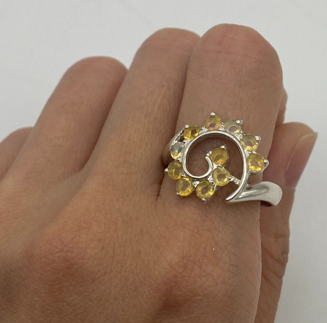 Flower Opal Ring worn on index finger with bare nails, perfect for adding a boho statement and enhancing personal expression, believed to bring joy as an October birthstone gift, ideal for day parties and brunch outings.