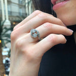 Opal Two-Stone Bypass Wave Ring worn with a black V-neck dress and paired with matching earrings, showcasing the opal’s fire colors and wave bypass design accented by CZ pave. A sophisticated October birthstone accessory, ideal for gala dinners, cocktail events, and festive celebrations.