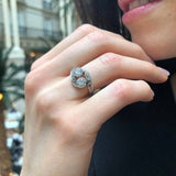 Opal Two-Stone Bypass Wave Ring worn with a black V-neck dress and paired with matching earrings, showcasing the opal’s fire colors and wave bypass design accented by CZ pave. A sophisticated October birthstone accessory, ideal for gala dinners, cocktail events, and festive celebrations.