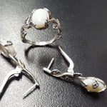 White Opal cabochon vine and leaf ring crafted in solid 925 sterling silver, featuring a nature-inspired design with flashes of fire colors. The durable vine-style band offers elegance and uniqueness while remaining comfortable for daily wear. As the October Birthstone, White Opal makes a thoughtful gift for birthdays, anniversaries, and nature lovers. Perfect to wear at weddings, outdoor celebrations, and festive gatherings.