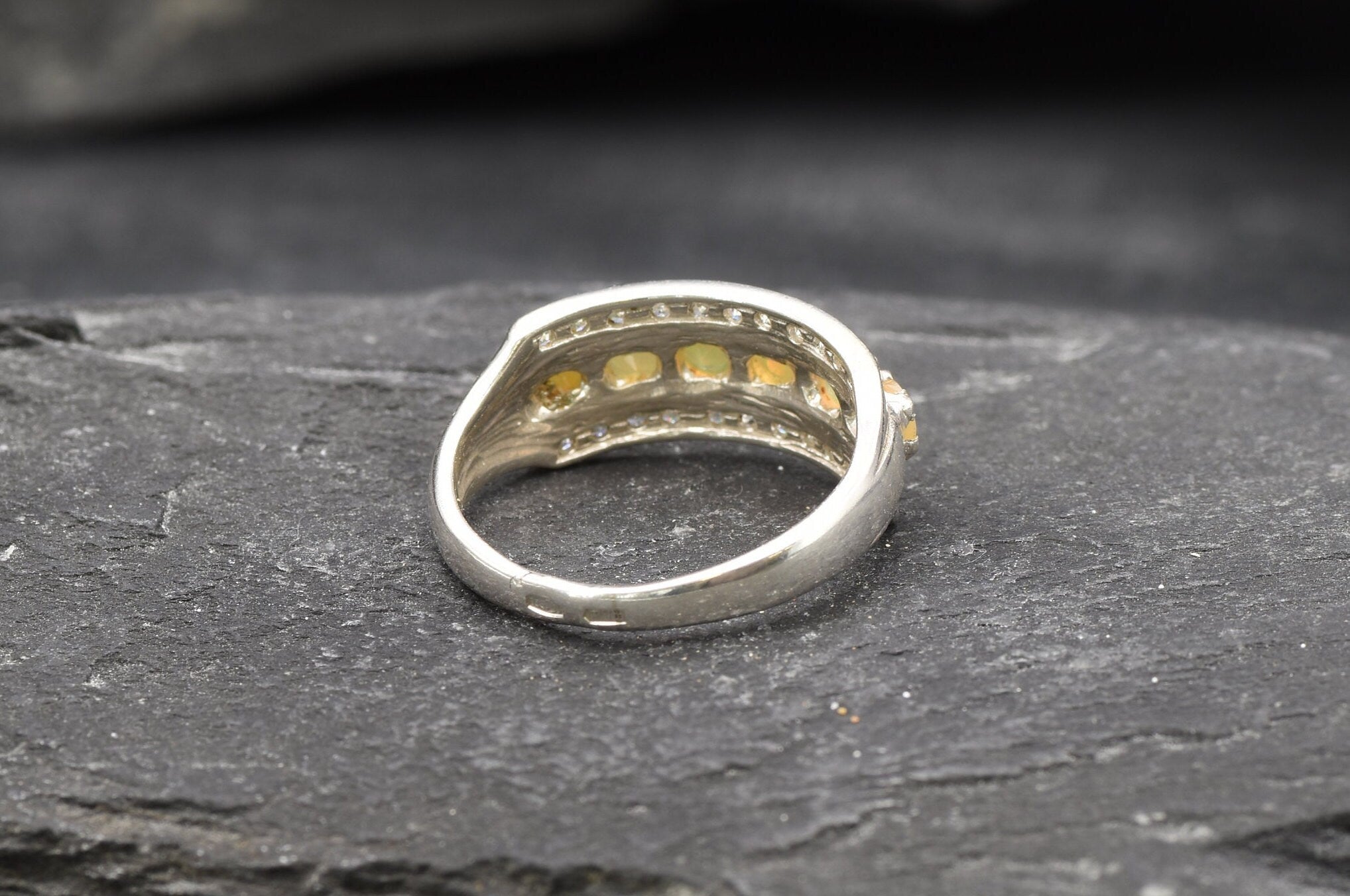 Opal Row Half Eternity Wide Ring in sterling silver featuring natural fire opals with flashes of fire colors, accented by CZ pave for a bold jewelry style. A meaningful October birthstone piece symbolizing balance and inspiration, making it a treasured gift idea. Perfect for weddings, anniversaries, cocktail events, and elegant evening occasions.