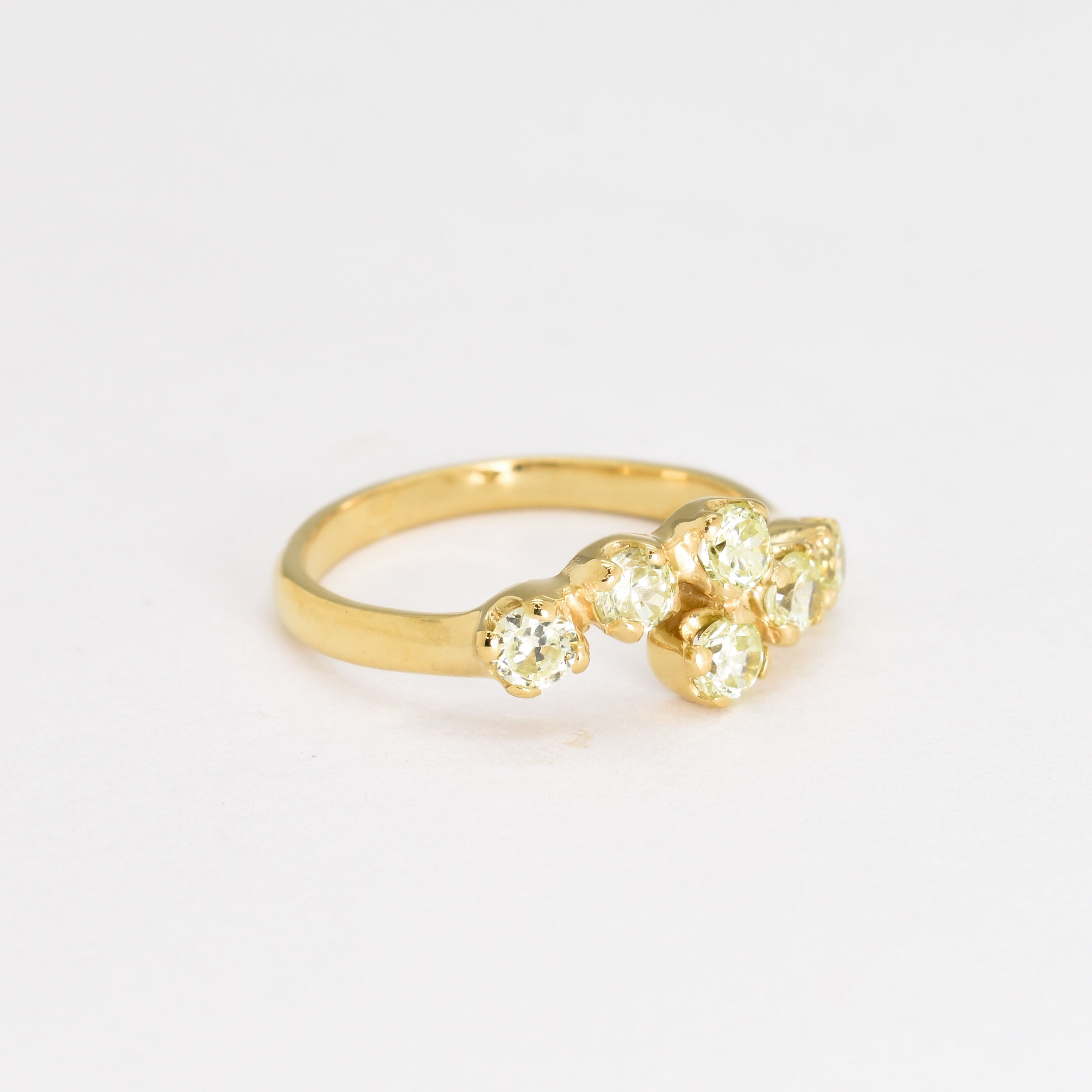 Peridot gold band ring crafted with brilliant diamond cut peridot stones, offering a luxurious and stylish accessory for gemstone lovers.