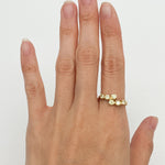 Peridot gold ring paired with minimalist accessories, great for professional or casual settings, complementing neutral and warm-toned outfits.