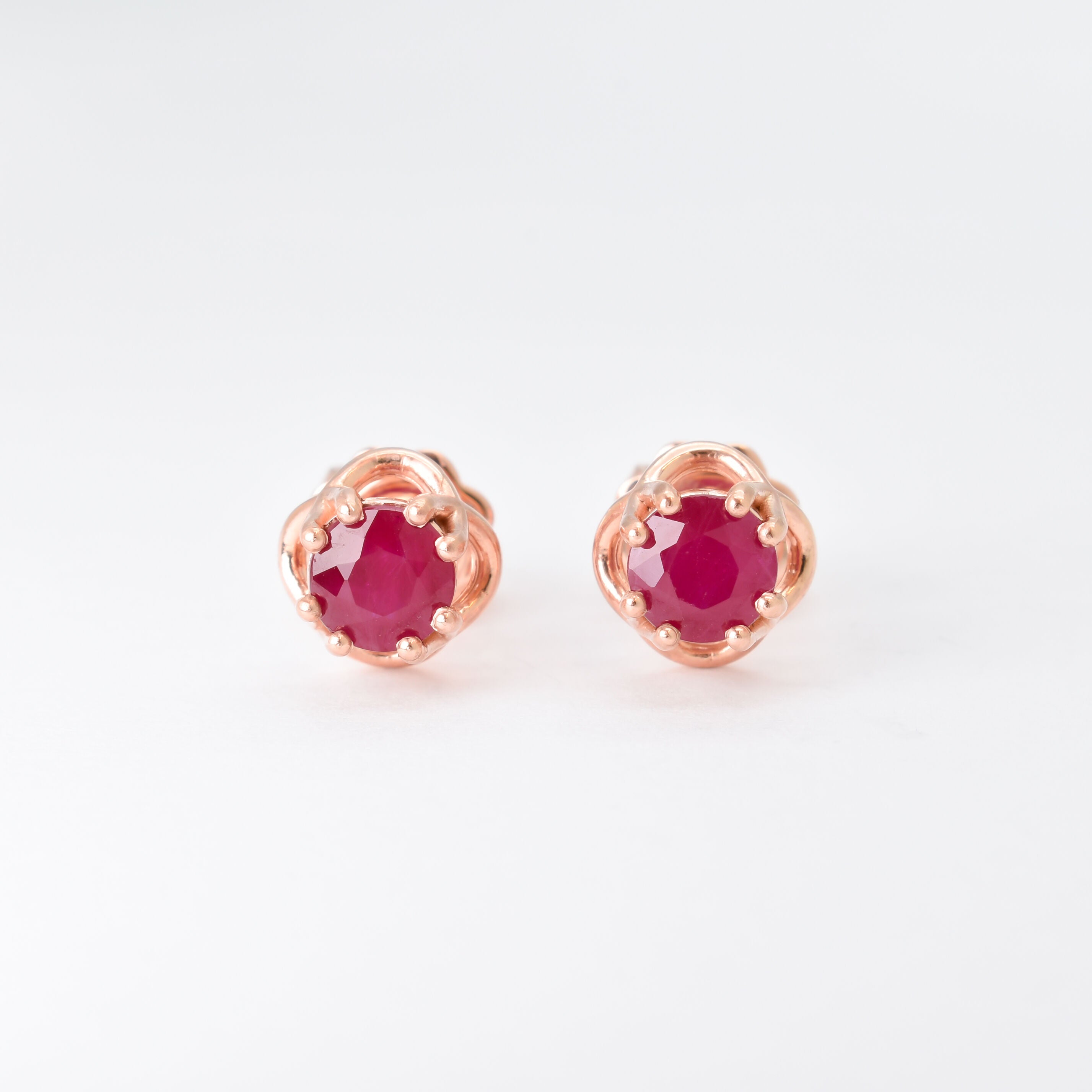 Real Ruby Earrings set in Solid 14k Rose Gold, in a prong setting, round cut, and natural red color. July birthstone earrings symbolizing real love and success. Dainty flower ruby studs perfect for everyday wear