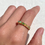 Rose Gold Half Eternity Opal Band worn on index finger with bare nails, offering creative energy and charm, great for stacking at casual outings or festive gatherings.