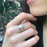 White Opal Bezel Ring paired with sleek hair and minimalist accessories. Jewelry style is timeless solitaire design with a cabochon stone that glows with fire colors and rainbow flashes. Brings emotional balance, clarity, and inspiration. A thoughtful October birthstone gift for anniversaries or birthdays. Perfect for formal dinners, weddings, and everyday elegance.